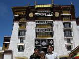 Tibet Lhasa 03 05 Peter Ryan With Chinese Tourists In Potala Deyang Shar Courtyard We had to stop to catch our breath several times as we climbed up to the entrance behind the Potala. We entered the large courtyard known as Deyang Shar, in front of the White Palace. I was so beat from the altitude I sat down and drank a Pepsi. There was a young Chinese tourist couple also enjoying a rest. They thought Peter Ryan was cute, and had their picture taken with him.